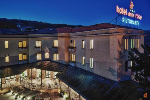 a hotel building with a sign on top of it at Hotel Delle Rose in Cascia