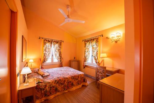 a bedroom with a bed and two windows at Il Mandorlo - Agriturismo e Azienda Agricola Ferrato in Ancona
