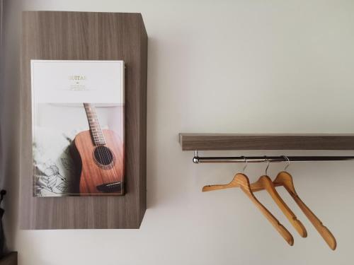 a picture of a guitar in a wooden box at Nana Beach Hotel & Resort in Pathiu