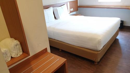 a bedroom with a large white bed in a room at BIZ HOTEL City Center in Ambon