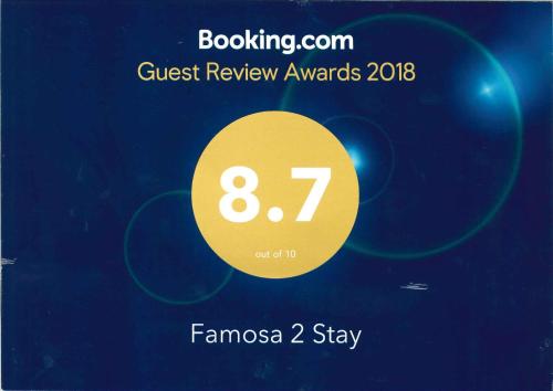 a poster for a guest review awards with a yellow circle at Famosa 2 Stay in Melaka