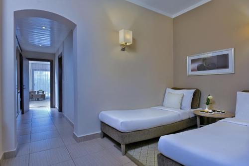 a hotel room with two beds and a balcony at Steigenberger Alcazar in Sharm El Sheikh