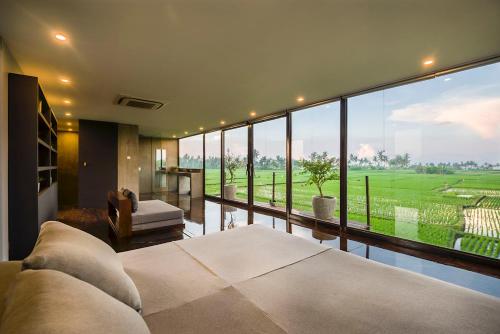 a living room with a large window with a view at Kontiki Villa - Joshua District in Tabanan