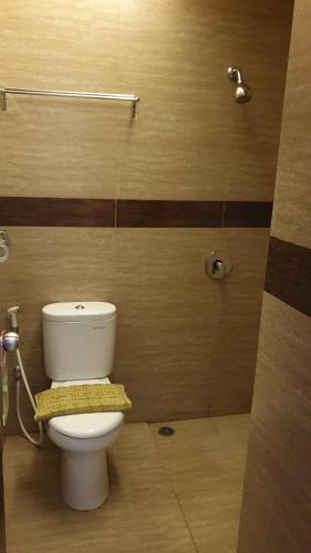 a bathroom with a white toilet in a room at BIZ HOTEL City Center in Ambon
