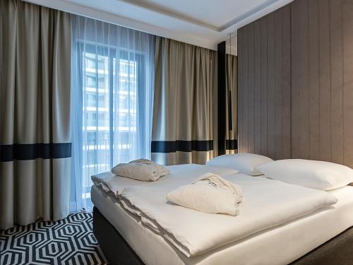 Posteľ alebo postele v izbe v ubytovaní VacationClub – Baltic Park Fort Apartament F.311