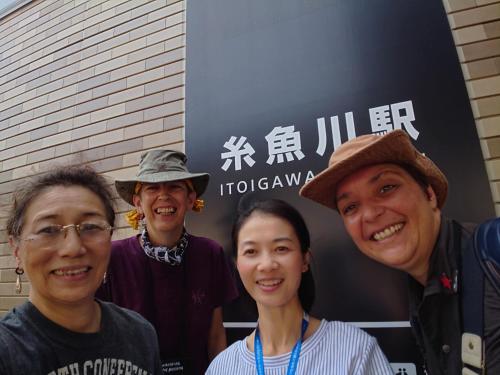 a group of people standing in front of a sign at Live Cafe Hisui no Umi in Itoigawa