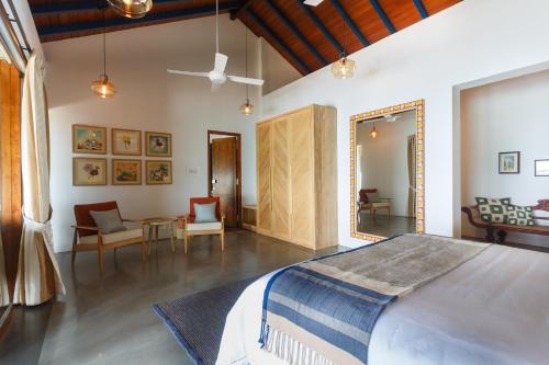 a bedroom with a bed and a living room at Bay Villas Balapitiya in Balapitiya