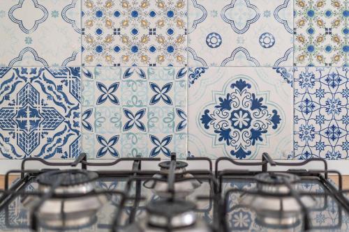 a stove top with blue and white tiles on a wall at Smiling Apartments Vico Equense in Vico Equense