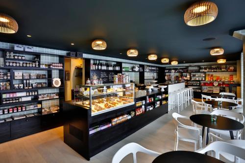 a restaurant with tables and a display of food at Hotel Stäfeli in Lech am Arlberg