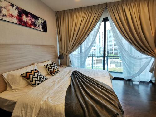 a bedroom with a bed and a large window at Almas Suites Studio Seaview Netflix By STAY in Nusajaya