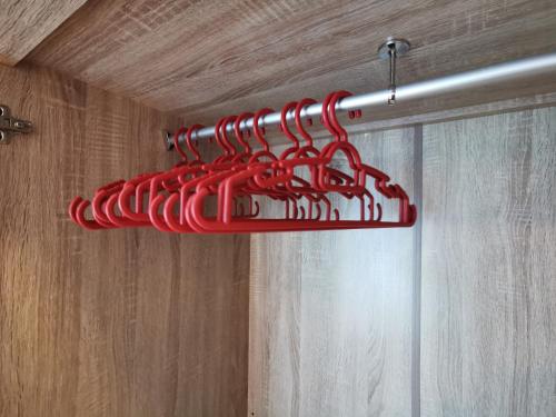 a bunch of red hangers hanging from a ceiling at Almas Suites Studio Seaview Netflix By STAY in Nusajaya
