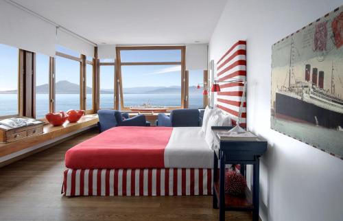 a bedroom with a bed and a view of the ocean at Maison La Minervetta in Sorrento