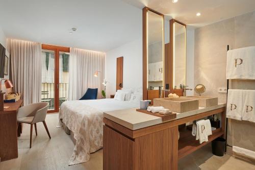 a hotel room with a bed and a bathroom at Es Princep - The Leading Hotels of the World in Palma de Mallorca