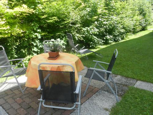 a table and chairs with a television on it at Haus Wittig in Sankt Ulrich am Pillersee