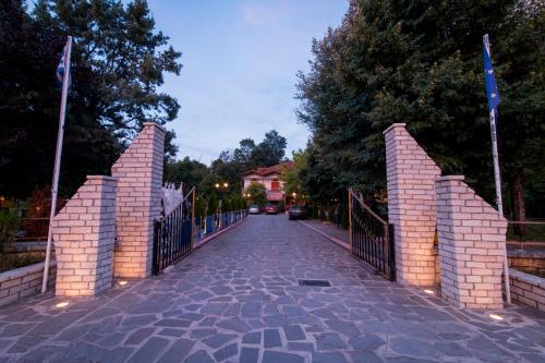 a brick bridge with a gate on a street at Krikonis Hotel in Ioannina