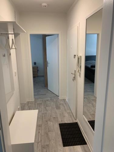 a room with a hallway with a mirror and a bathroom at FeWo in Sterkrade in Oberhausen