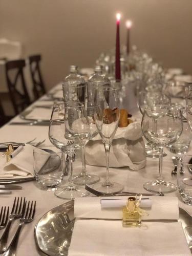 a table with wine glasses and a candle on it at Relais Santo Stefano in Sandigliano