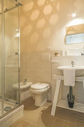 a bathroom with a toilet and a sink and a shower at River View in Fiumicino