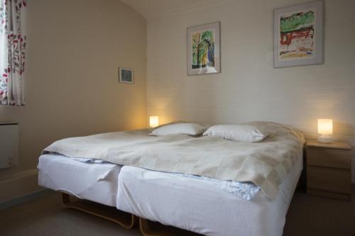 a bedroom with a bed with two pillows on it at Motel Herning in Kibæk