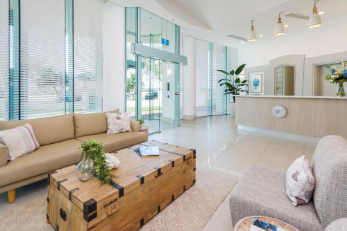 a living room with a couch and a coffee table at The Waterford on Main Beach in Gold Coast