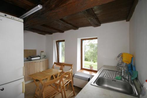 a kitchen with a sink and a table at Chuchi Guest House 1 in Zlatna Panega