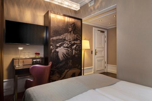 Säng eller sängar i ett rum på Elite Plaza Hotel