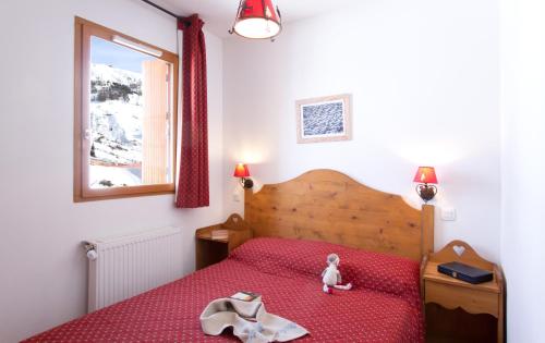 Ένα ή περισσότερα κρεβάτια σε δωμάτιο στο Résidence Odalys Rochebrune