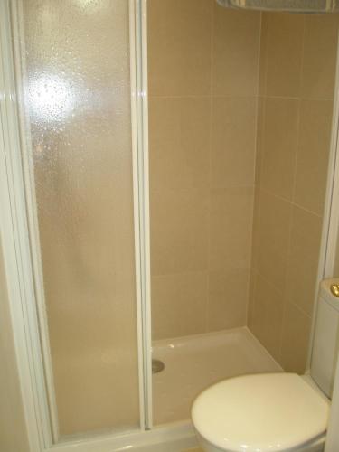 a bathroom with a shower and a toilet at Roses Holiday Center 2408 in Roses