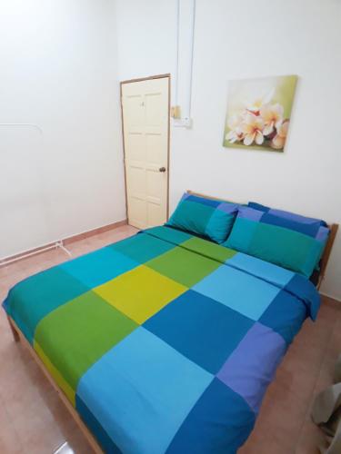 a bedroom with a colorful bed in a room at JJ Melaka Holiday home in Melaka