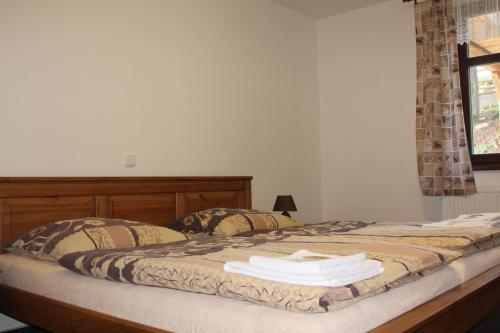 a bedroom with a bed with towels on it at Relax pension Schonwald in Budišov nad Budišovkou