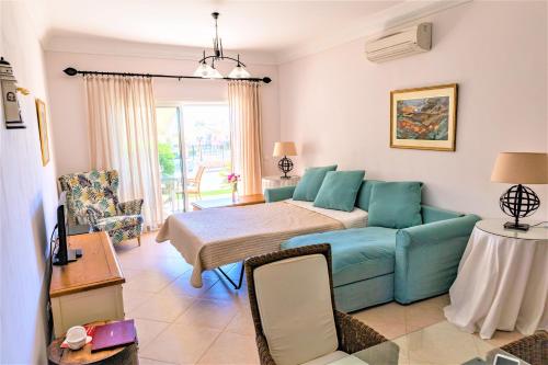 a living room with a blue couch and a table at Boavista Fairviews Village in Lagos