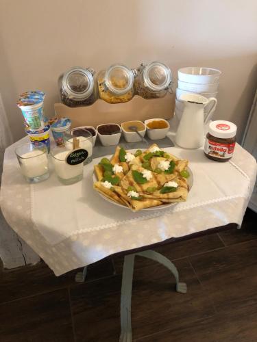a table with a plate of food on a table at Feniks Agro&Spa Adults Only in Świnoujście