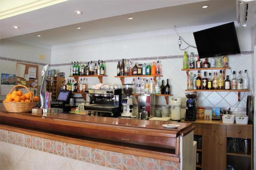 a bar in a restaurant with a counter top at Hotel Cabello in Torremolinos