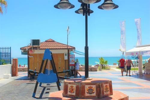 a playground with a suitcase and a swing at Hotel Cabello in Torremolinos