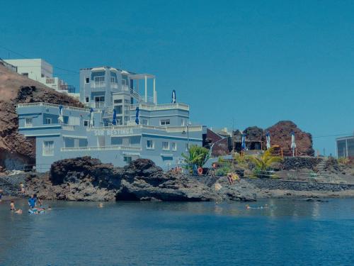 a large white building sitting on top of a body of water at Sur Restinga in La Restinga
