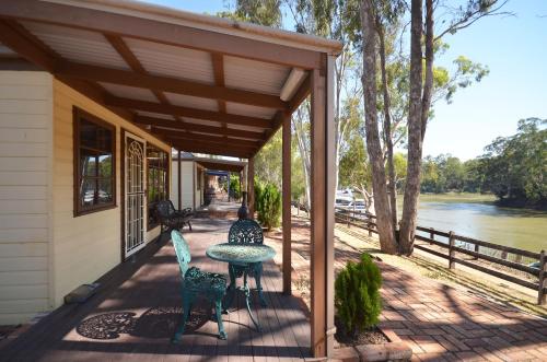 a patio with a table and chairs on a house at Tasman Holiday Parks - Merool on the Murray in Echuca