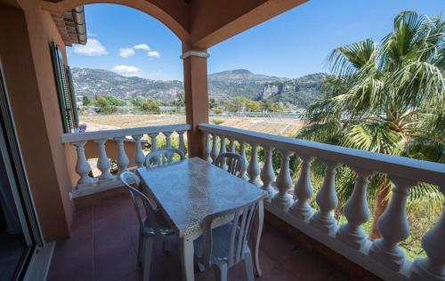 a balcony with a table and chairs and a view at Appart Hotel Lou Castelet in Carros