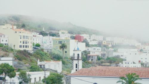 a view of a city with buildings and a mountain at Sur Restinga in La Restinga