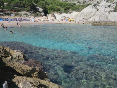 a group of people in the water at a beach at Heart of Pollensa in Pollença