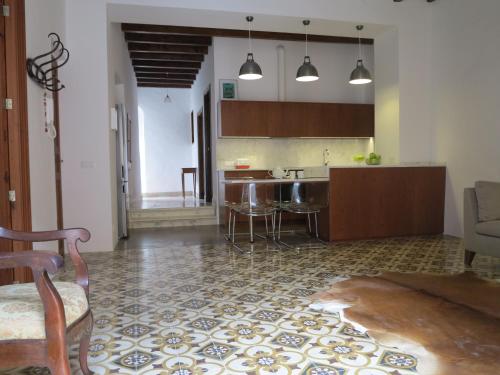 a kitchen with a table and chairs in a room at Heart of Pollensa in Pollença