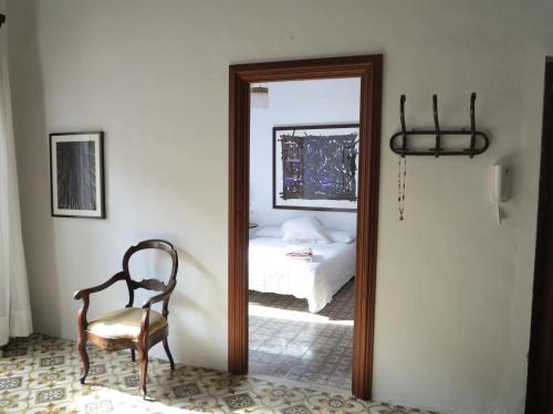 a mirror in a room with a bed and a chair at Heart of Pollensa in Pollença
