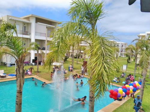 a pool at a resort with people playing in it at F3 Casabay beach sidi rahal vue sur piscine in Sidi Rahal