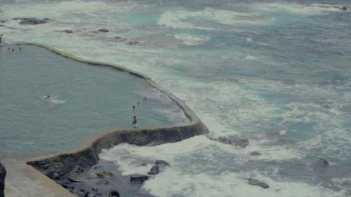 a group of people standing on the beach near the ocean at Sur Restinga in La Restinga