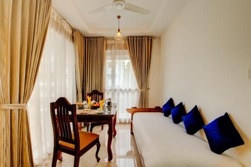 a living room with a couch and a table at Sterling Guruvayur in Guruvāyūr