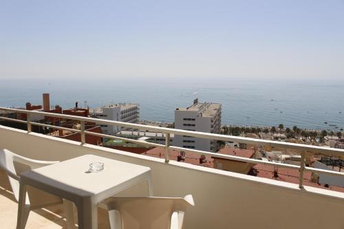 a balcony with a table and a view of the ocean at BLUESEA Gran Cervantes in Torremolinos