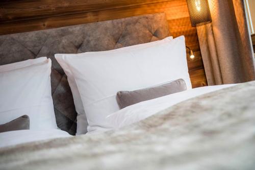 two white pillows on a bed in a room at BAD MOOS - Aqua Spa Resort in Sesto