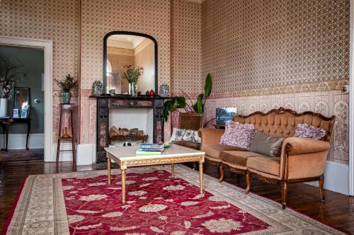 a living room with a couch and a table at Albert Hotel Daylesford in Daylesford