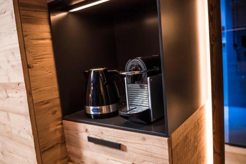 a coffeemaker is sitting on a shelf in a room at BAD MOOS - Aqua Spa Resort in Sesto