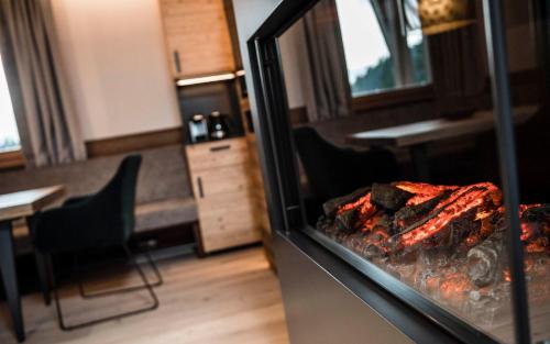 a room with a fireplace with food in it at BAD MOOS - Aqua Spa Resort in Sesto