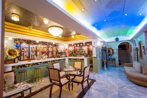 a bar in a restaurant with a table and chairs at Krikonis Hotel in Ioannina